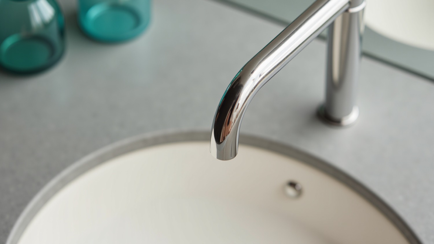 Close-up of a polished chrome faucet over a clean basin